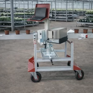 Pot labeling machine installed in an industrial greenhouse with conveyor system